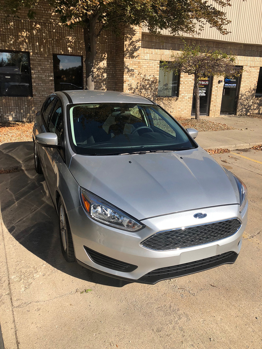 An image of a silver Ford car parked in a parking lot.